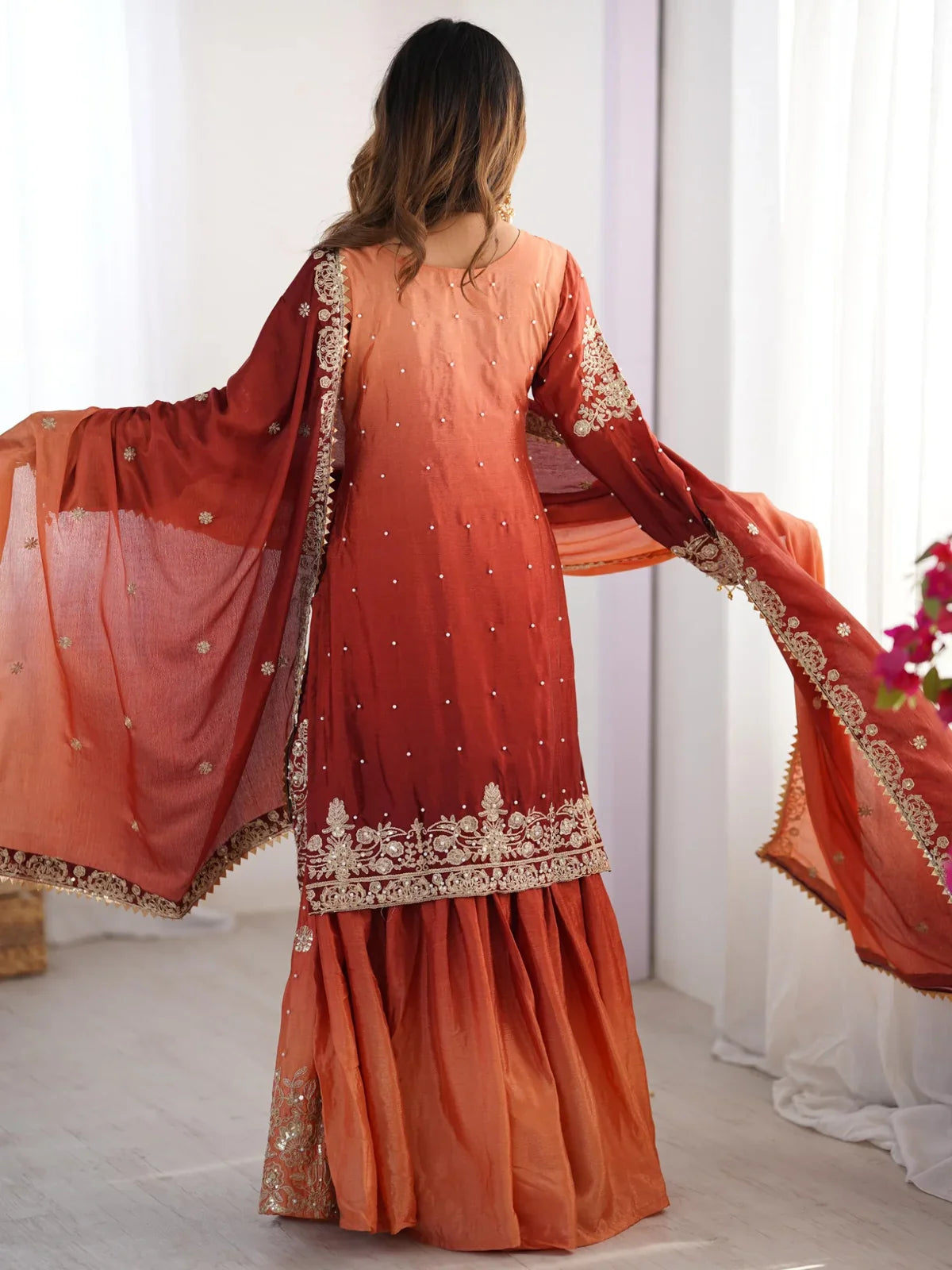 Tarani orange party wear chinon dress back view with embroidered dupatta spread