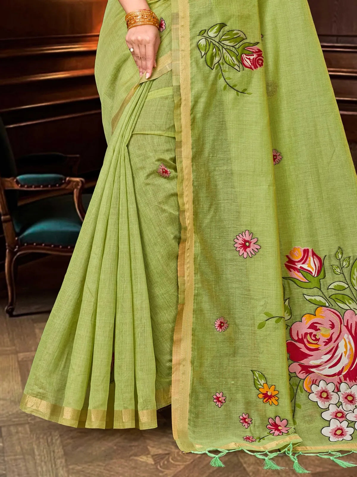Tarani green cotton blend saree closeup showing floral print and zari border