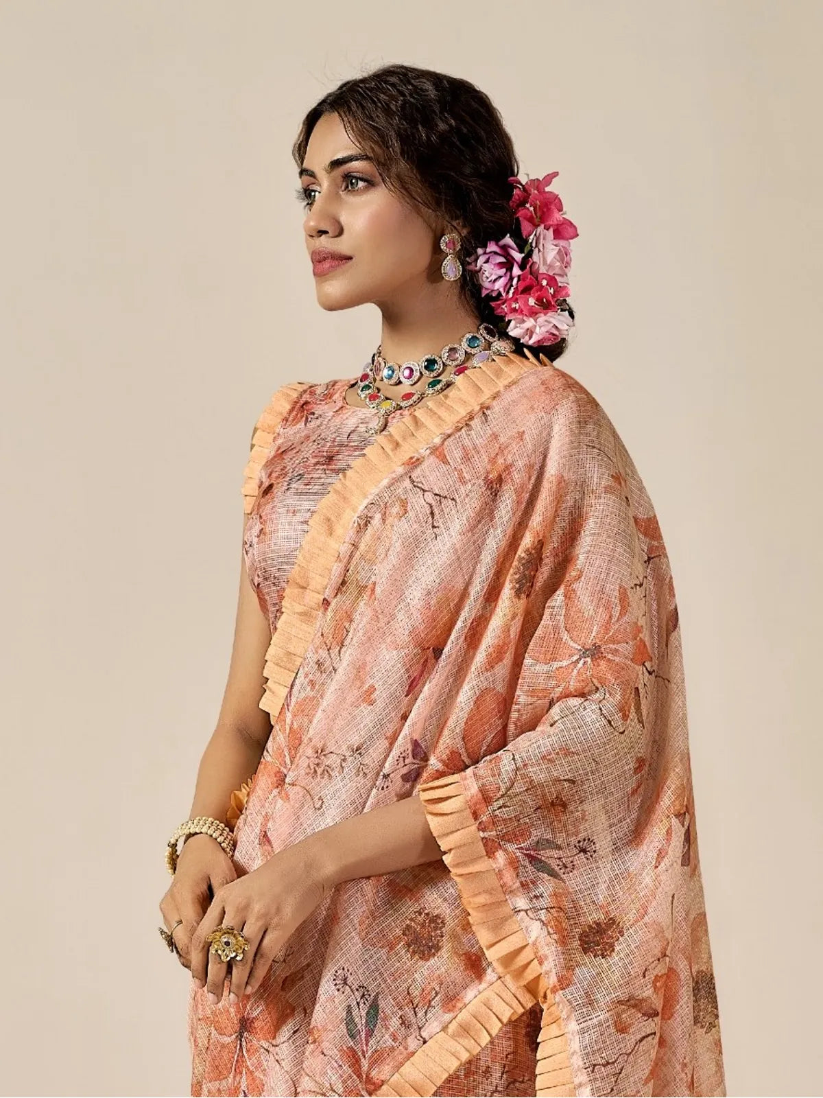 Tarani elegant upper body view of peach Kota cotton blend saree with floral design and soft drape