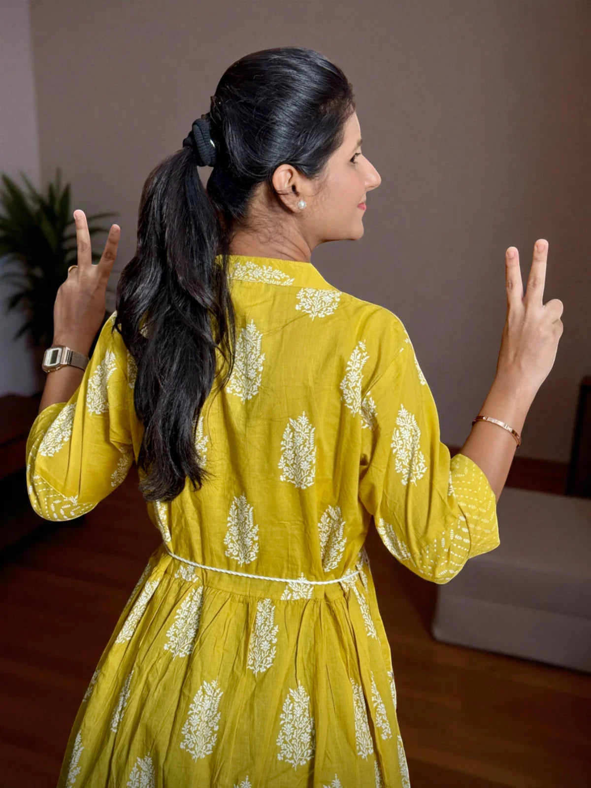 Tarani yellow midi dress back view with cotton texture and tie-back detail