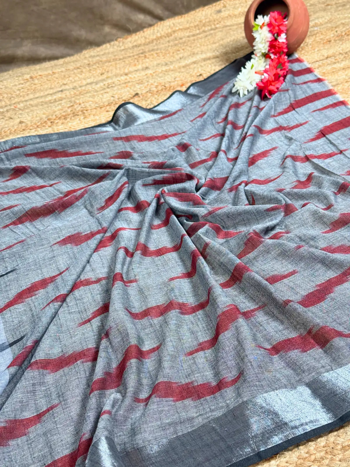 Tarani grey woven silk saree pallu view showing woven red grey detailing