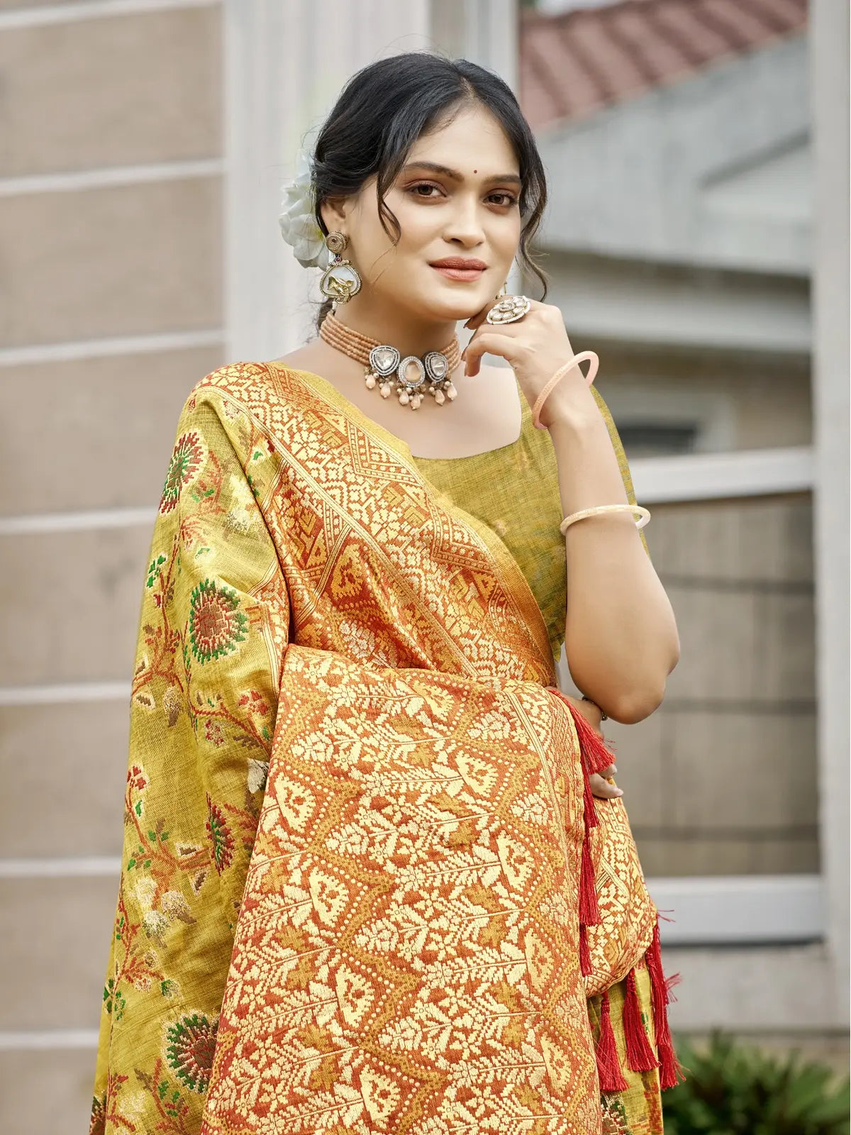 Tarani cotton silk green saree shown in upper body pose with intricate woven blouse