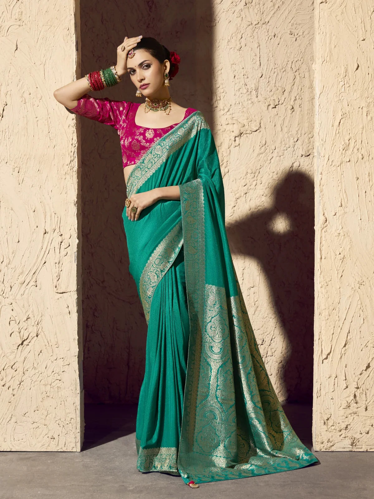 Tarani green crepe georgette saree with rich zari work and pink blouse perfect for weddings and festive wear