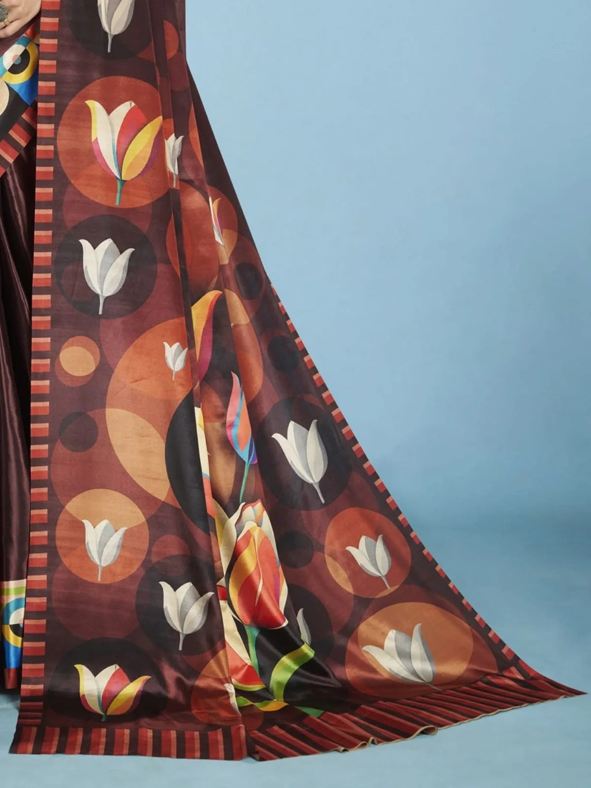 Tarani close-up view of modern floral pallu design on brown crepe party saree