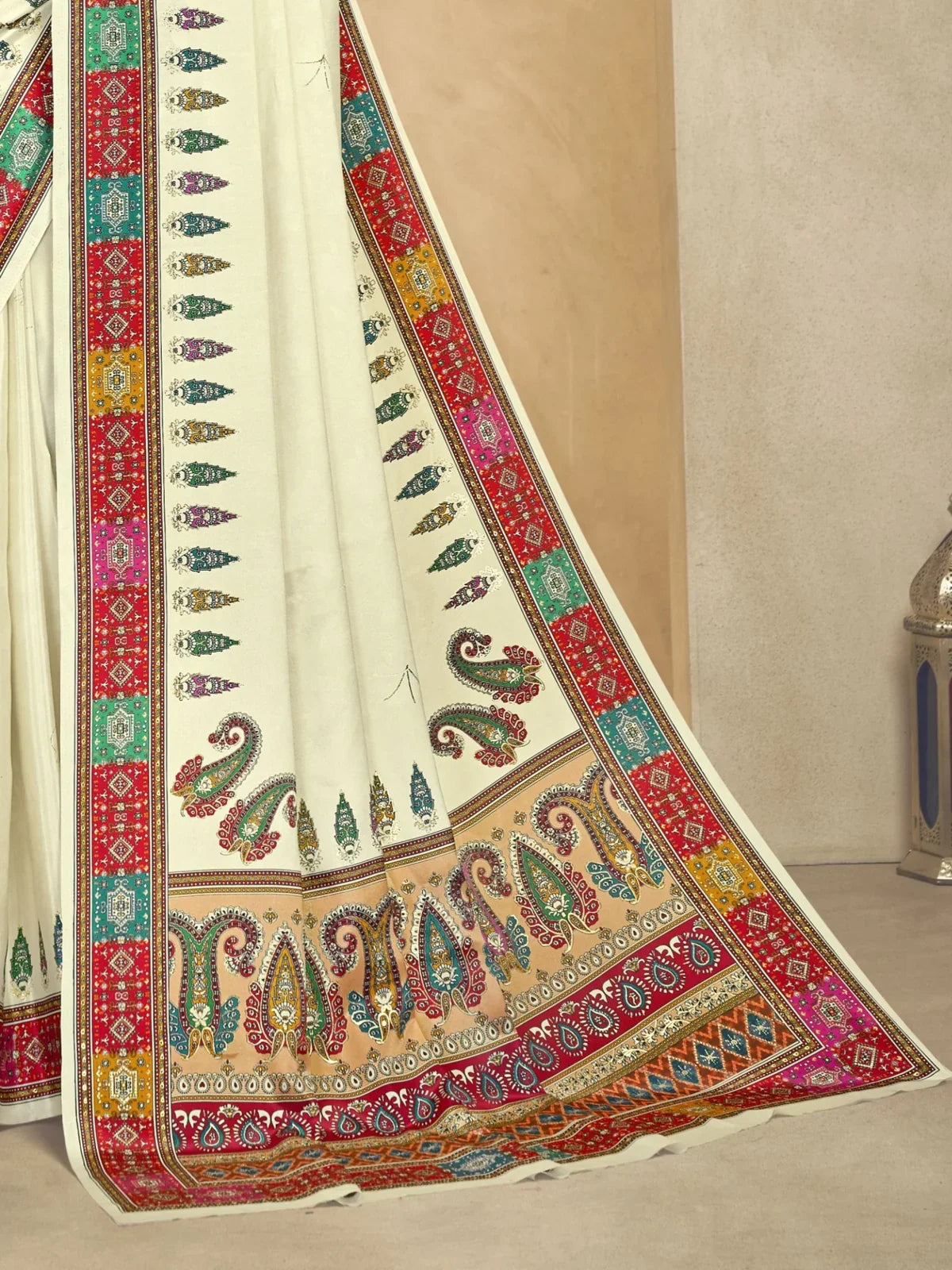Tarani cream crepe saree pallu view showing vibrant border and traditional motifs in detail