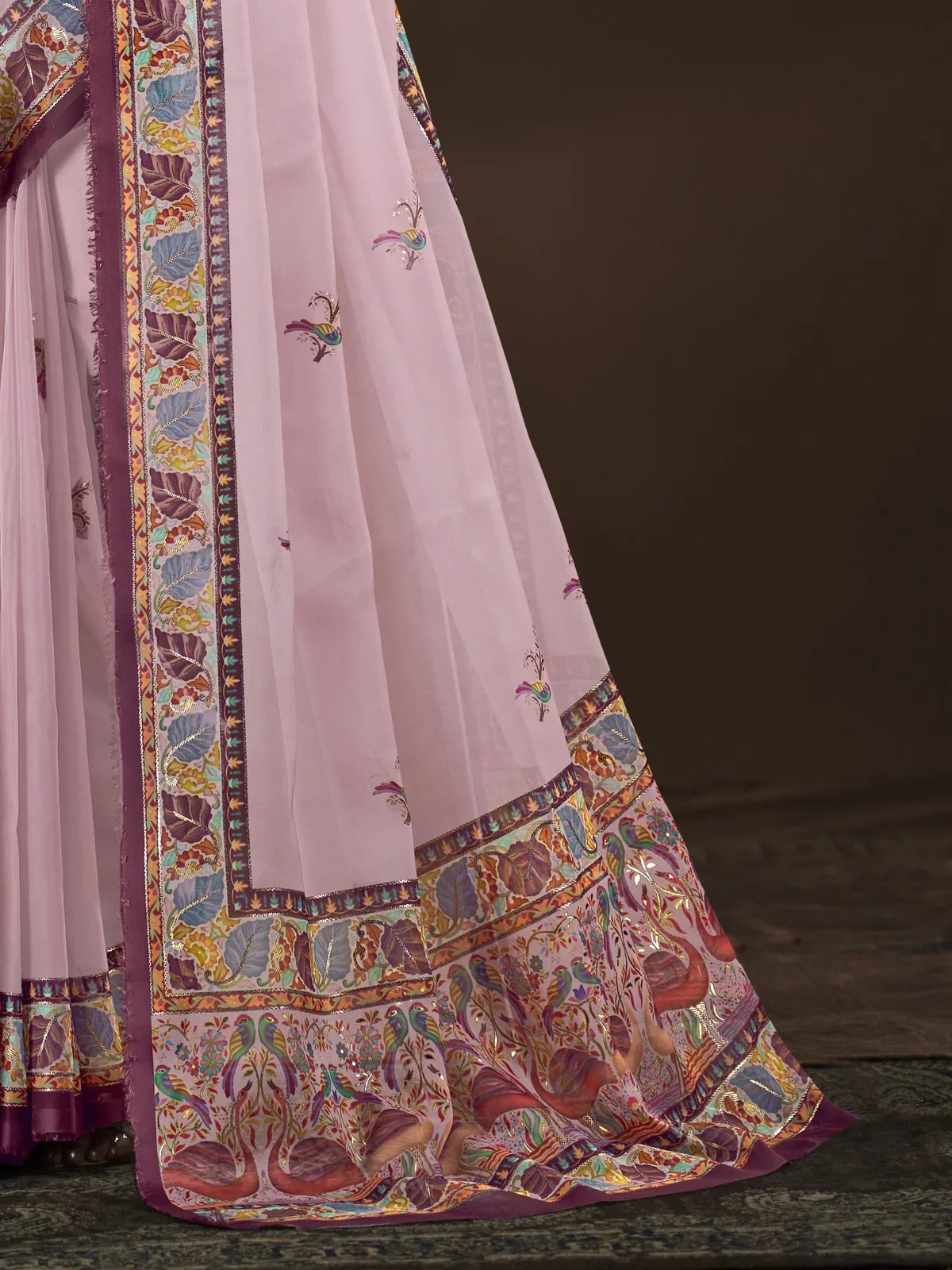 Tarani crepe saree closeup showing intricate multicolor border design and fine weave