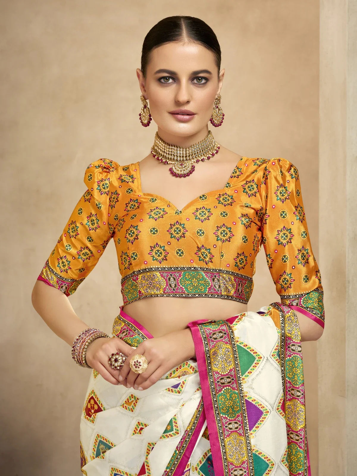 Tarani festive crepe saree with multicolor motifs and bright ochre printed blouse upper body view