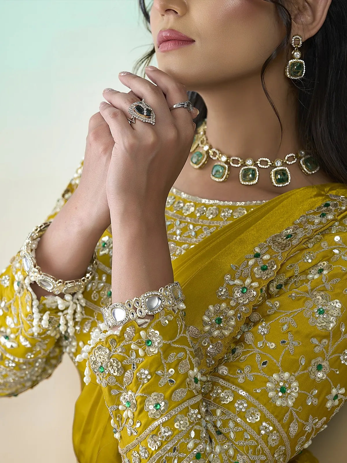 Tarani Aishika mustard saree closeup showing embellished blouse and detailed border work