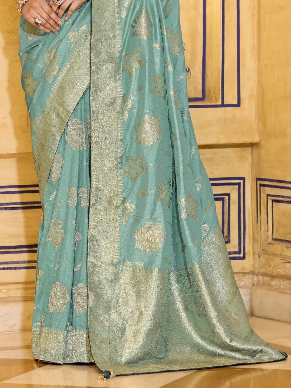 Tarani crepe silk saree pallu closeup showing zari border and fabric texture in green