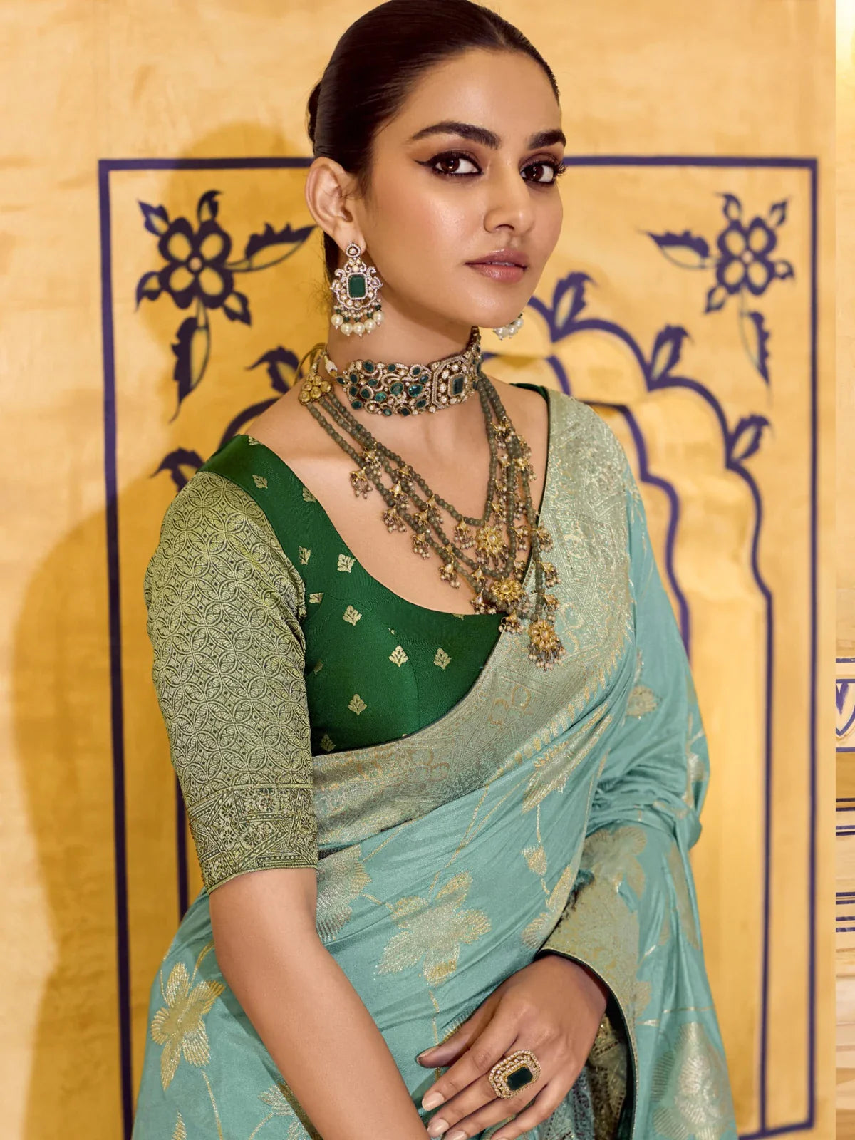 Tarani green crepe silk saree upper body pose with zari work and designer blouse