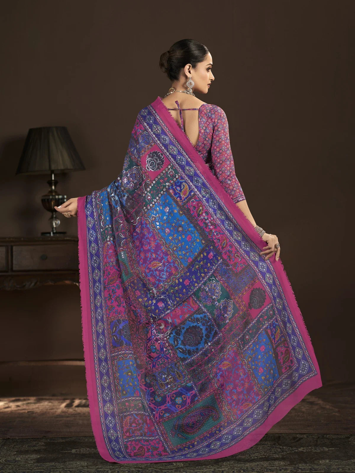 Tarani back pose of purple crepe silk saree showing detailed pallu design and blouse styling