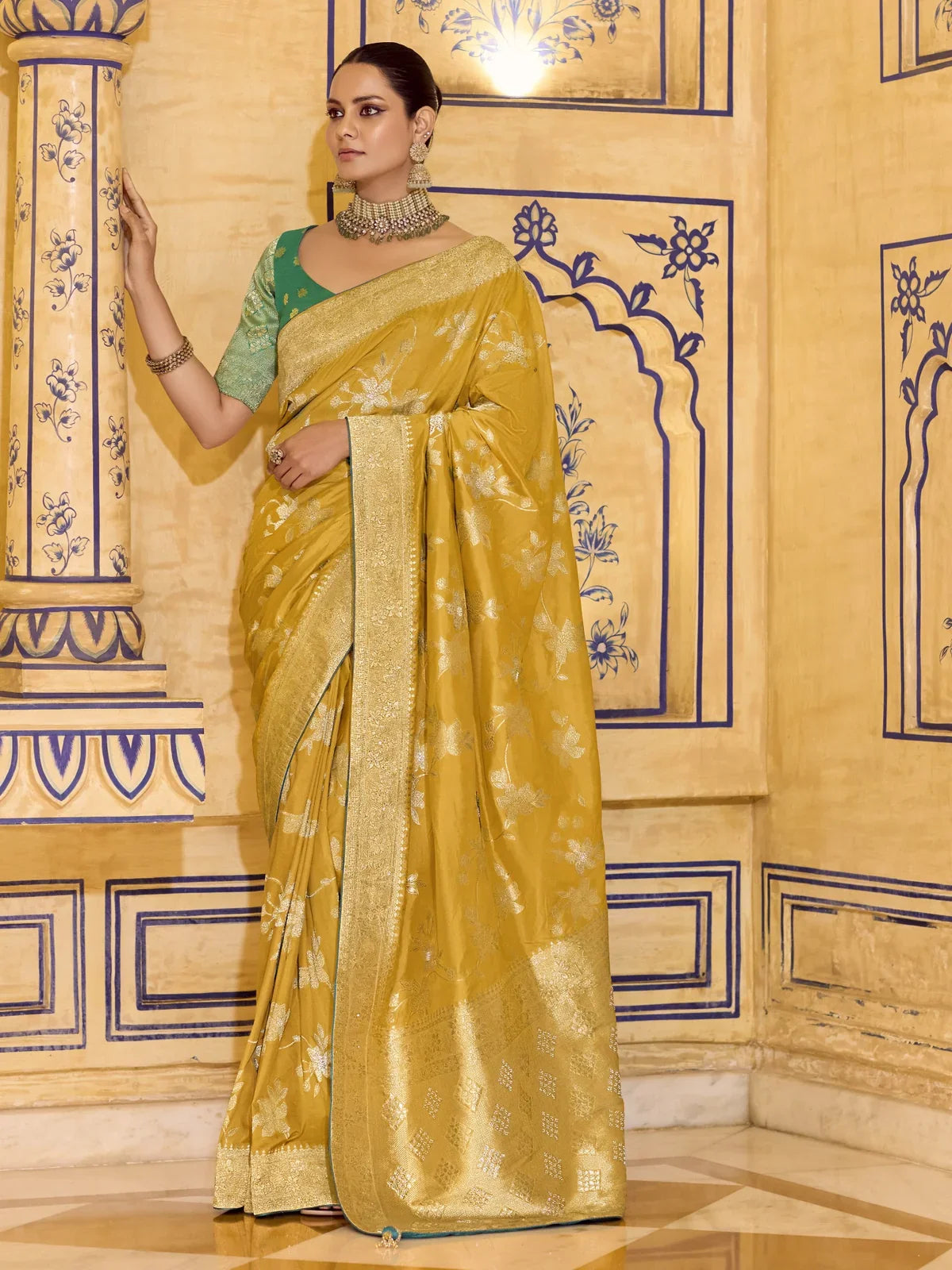 Tarani premium crepe silk saree in mustard yellow with green zari blouse front upper body view