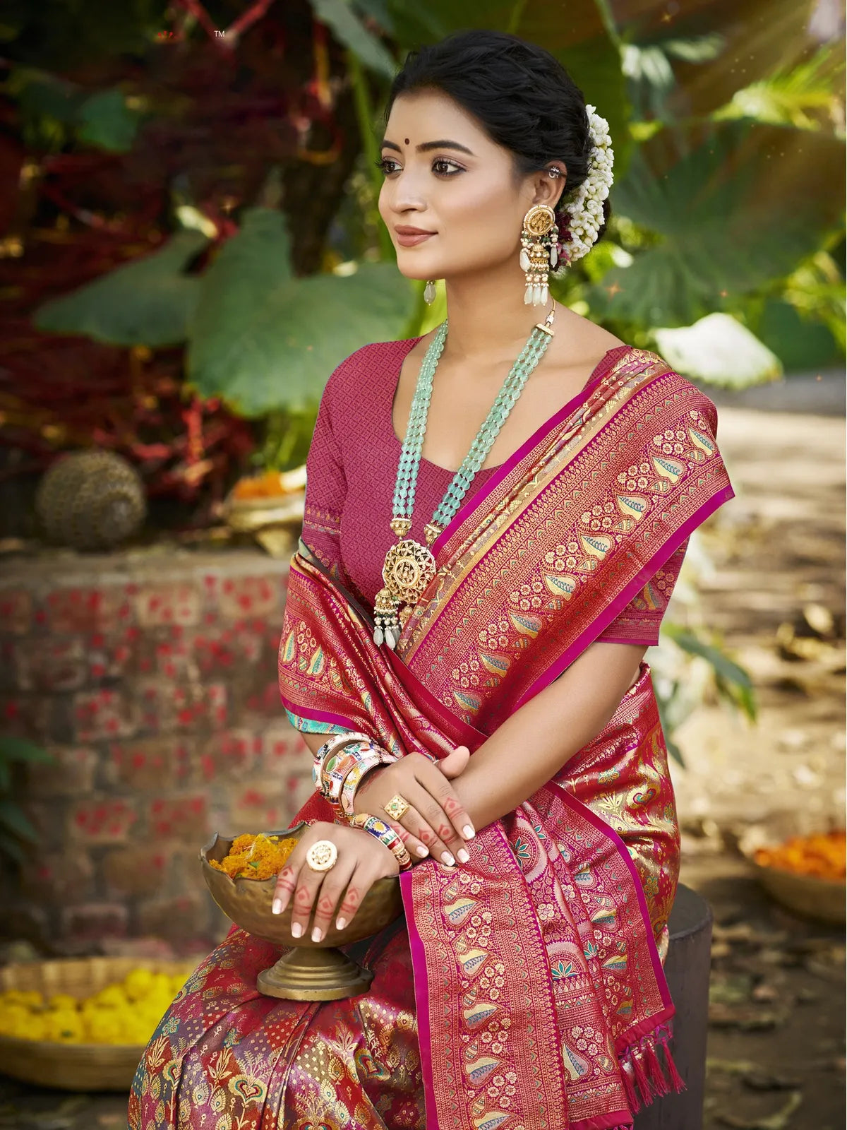 Tarani Dharmavaram pink saree upper body view with intricate zari work and ethnic jewellery