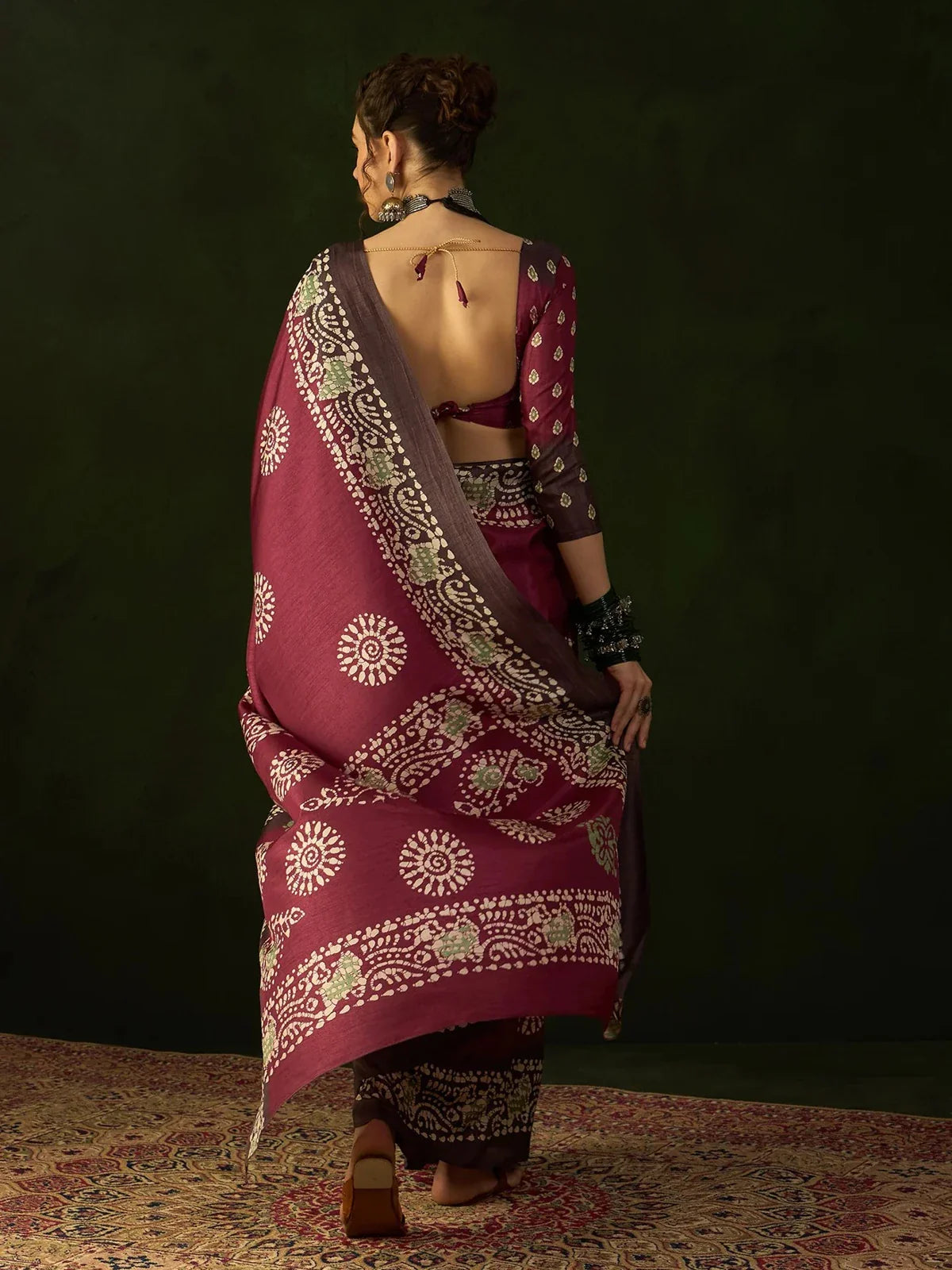 Tarani wine red saree back view highlighting blouse back design and pallu pattern