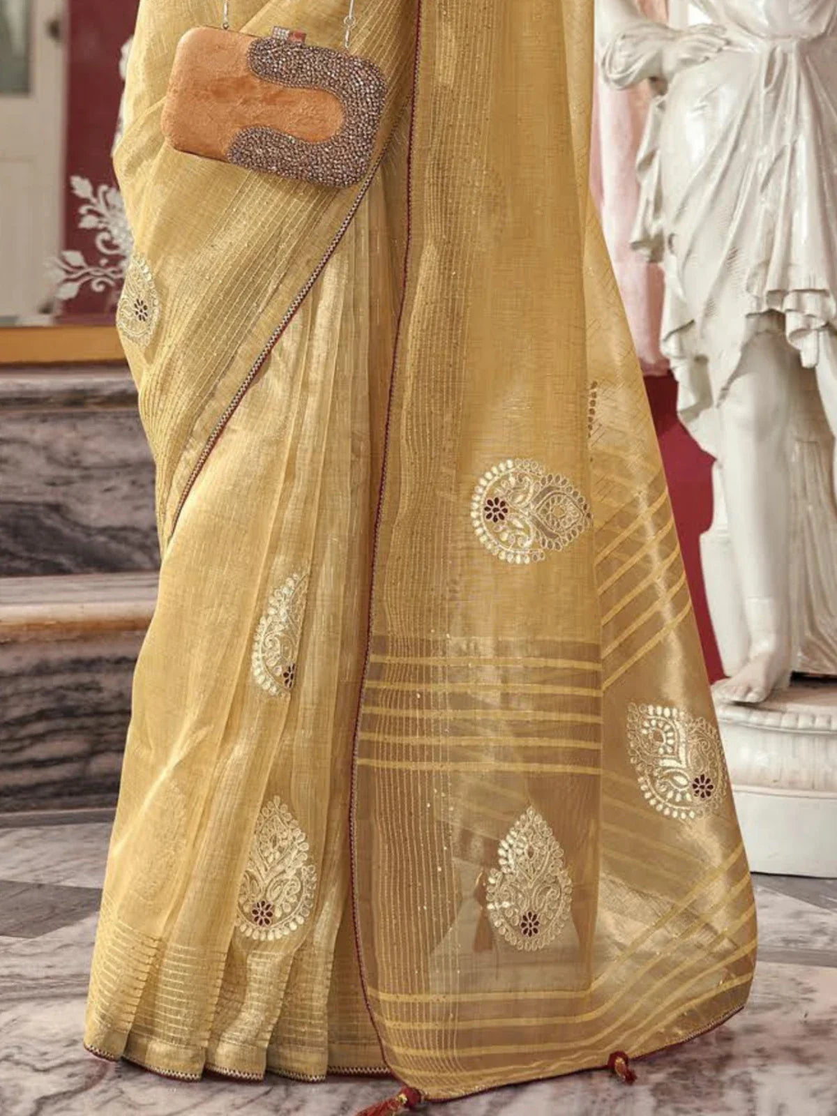 Tarani golden fancy saree closeup showing rich embroidery and shimmer texture
