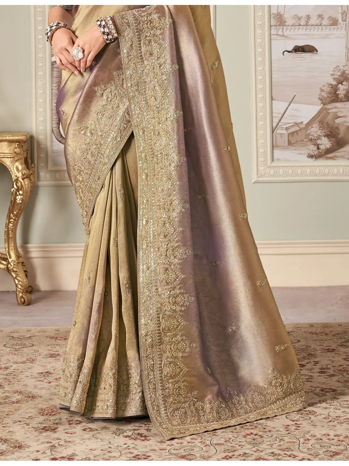 Tarani golden fancy saree pallu view showing detailed heavy cutwork border and rich fabric texture