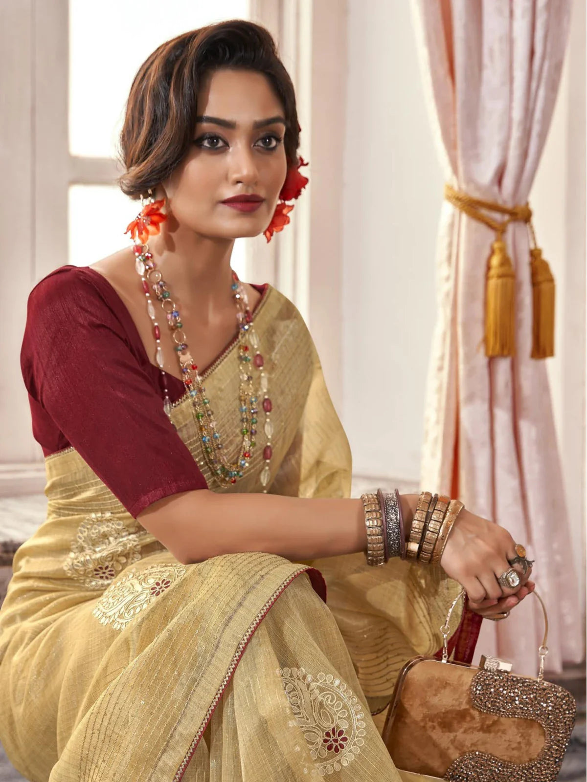 Tarani elegant golden saree upper body view showing maroon blouse and jewellery