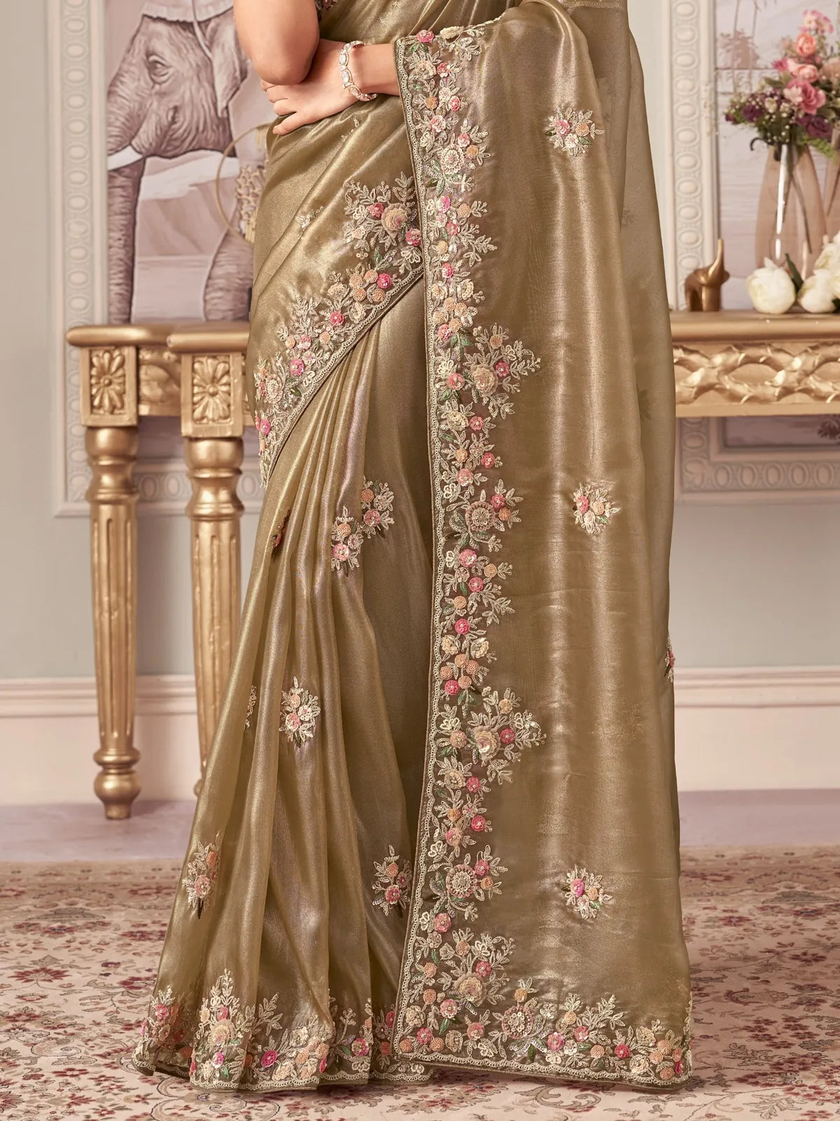 Tarani fancy green saree closeup view highlighting heavy cutwork border and floral embroidery