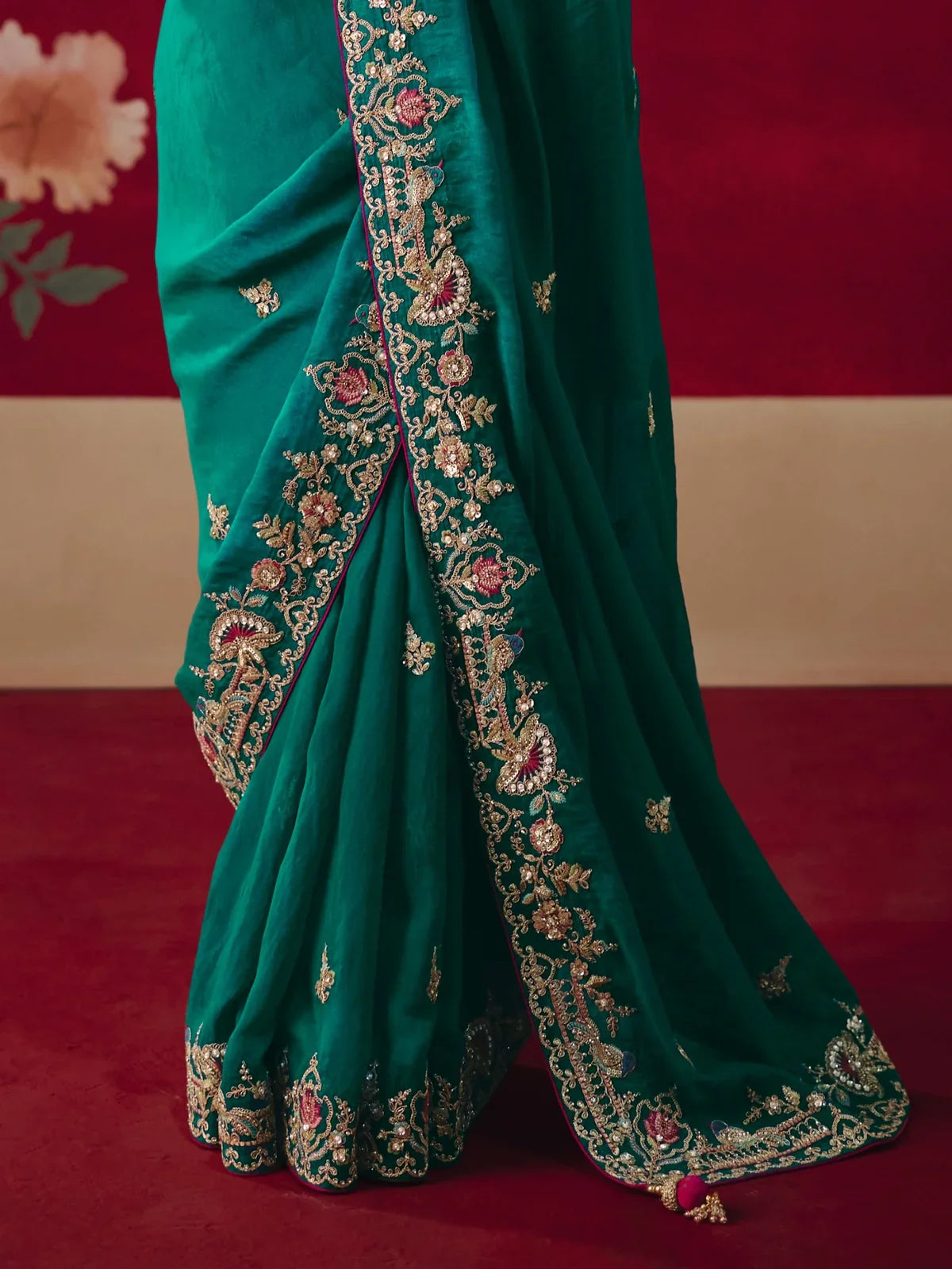 Tarani green saree close-up with fine zari border embroidery and elegant festive detailing