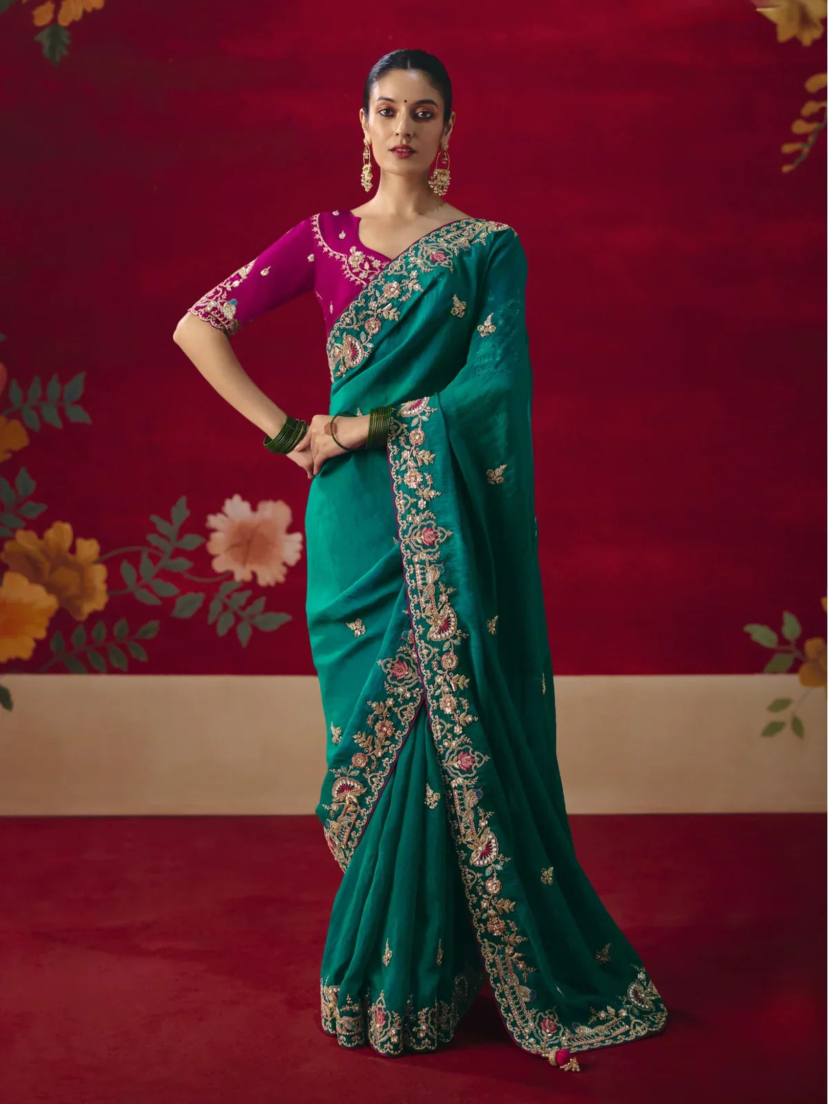 Tarani fancy green saree with zari and thread embroidery and magenta blouse for weddings and festive wear