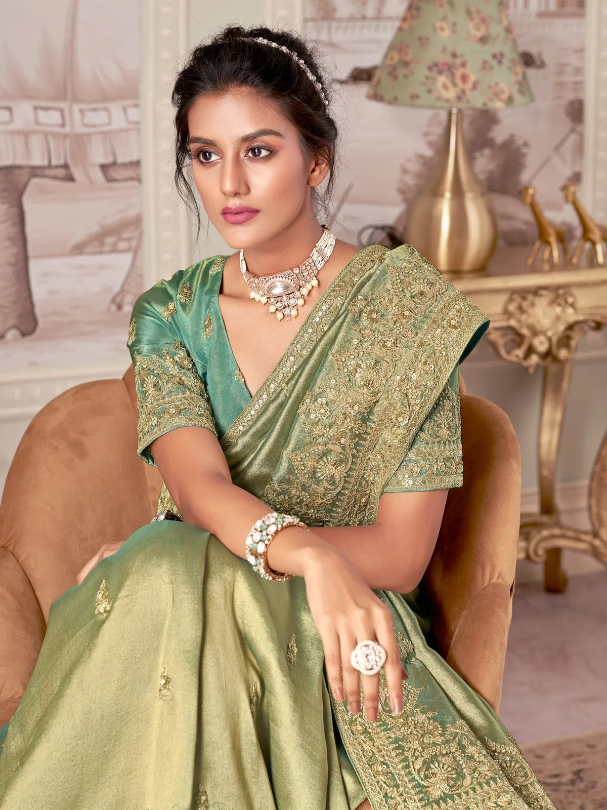 Tarani elegant green fancy saree upper body view showing blouse embroidery and jewelry styling