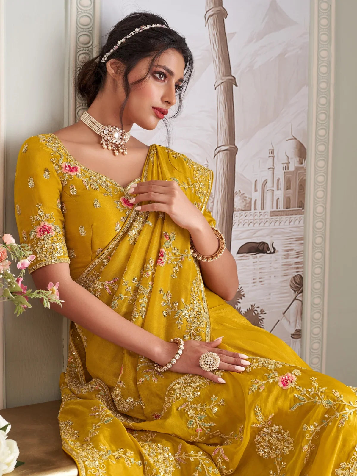 Tarani mustard fancy saree side pose highlighting embroidery details