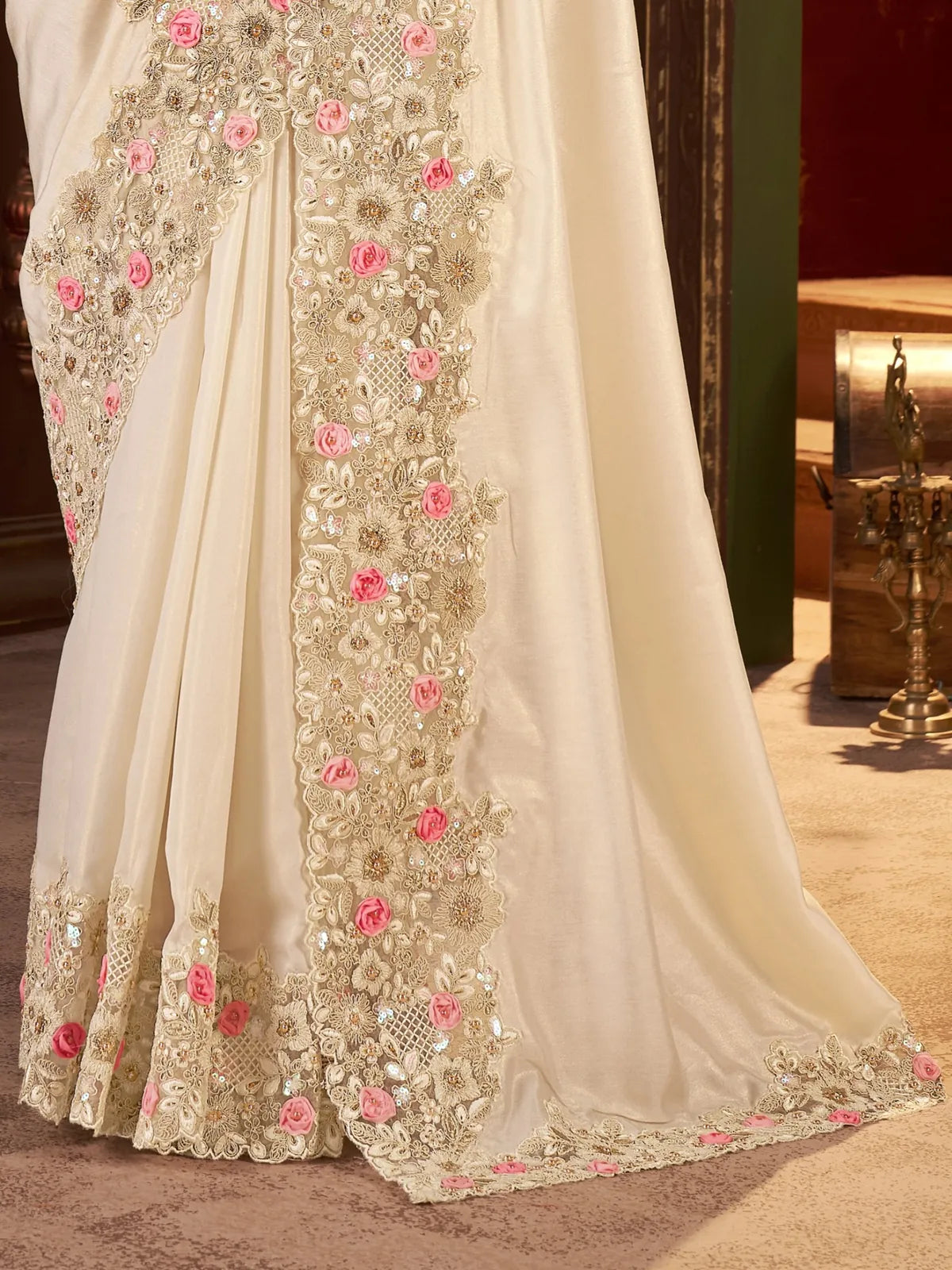 Tarani closeup of saree border with pink floral work and detailed zari embroidery