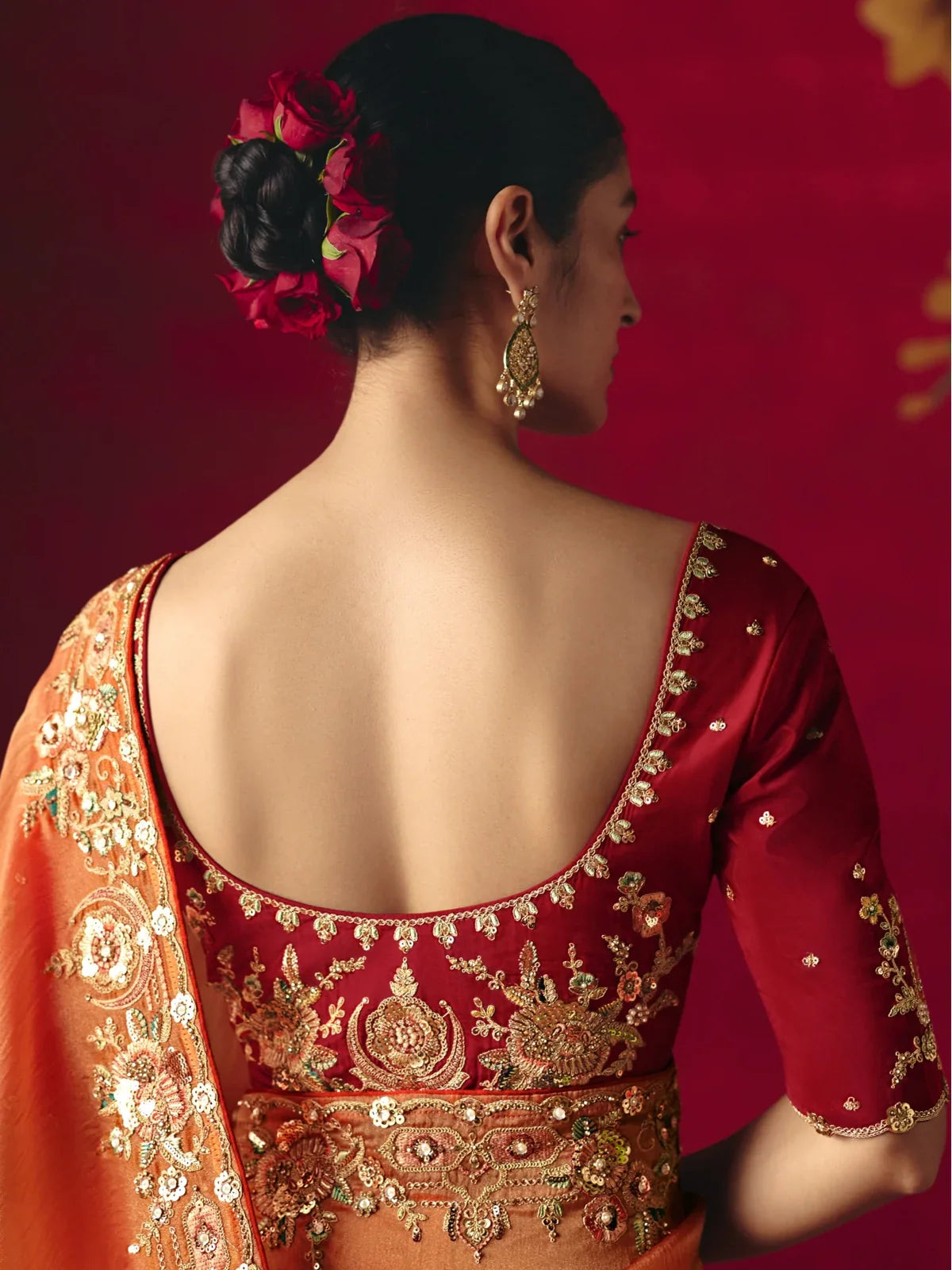 Tarani orange saree with deep maroon blouse back design and floral embroidery for weddings and parties