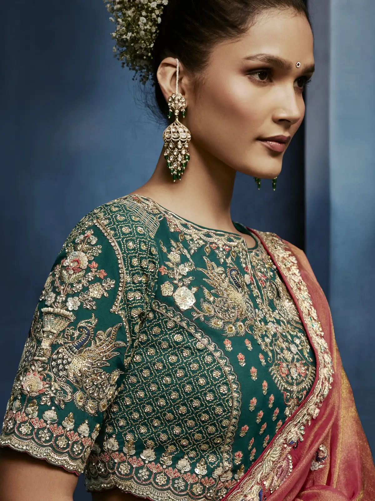 Tarani peach fancy saree side view with elegant border embroidery and festive styling
