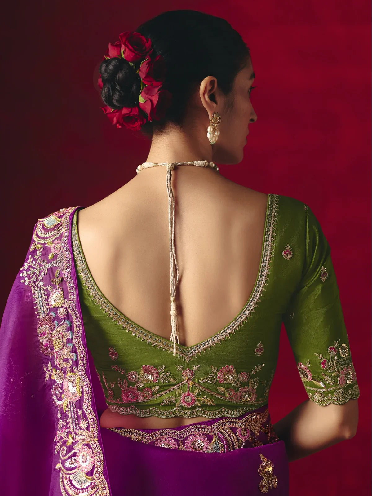 Tarani green blouse with pink floral embroidery and deep back neckline, styled for festive occasions