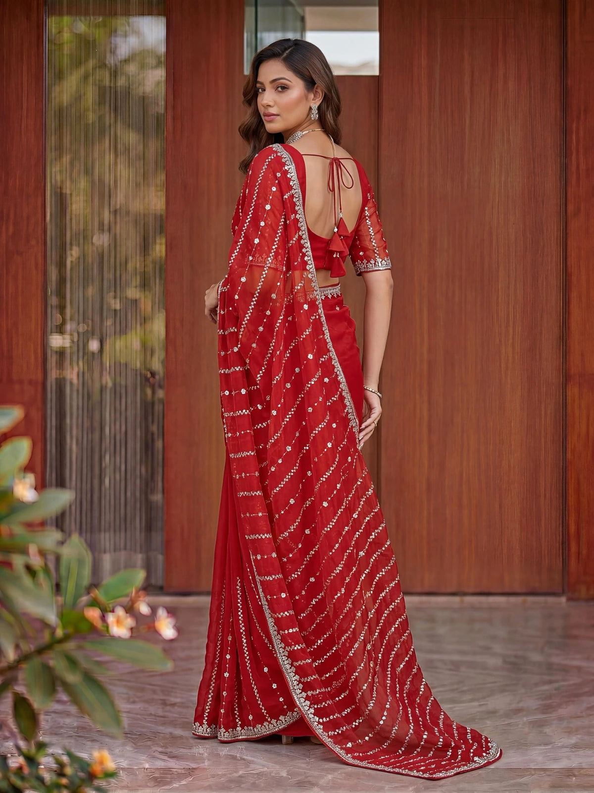 Tarani Raima red Fandy Satin saree back view featuring blouse back design and flowing pallu