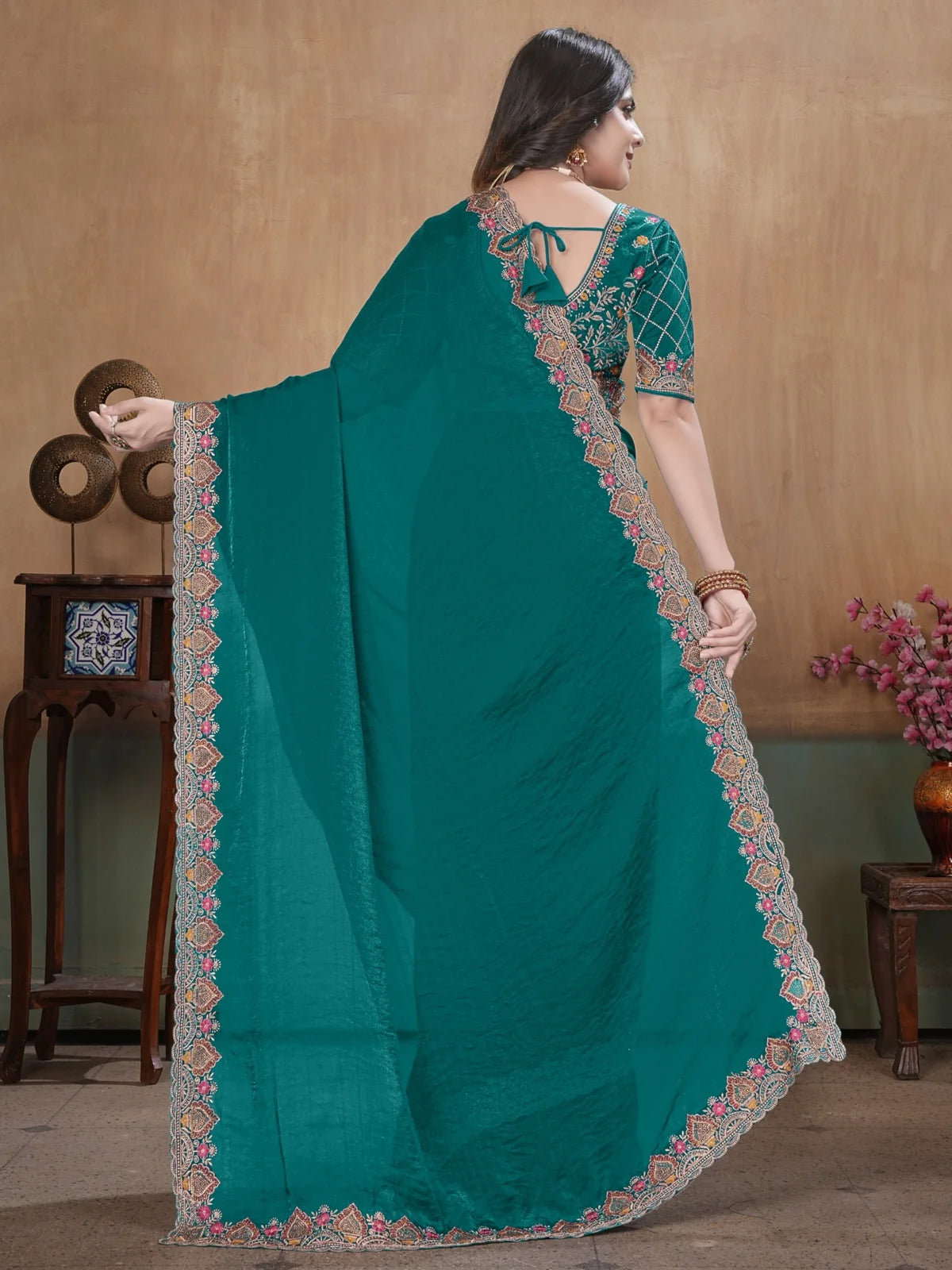Tarani back view of teal Soft Fandy Satin saree with embroidered border