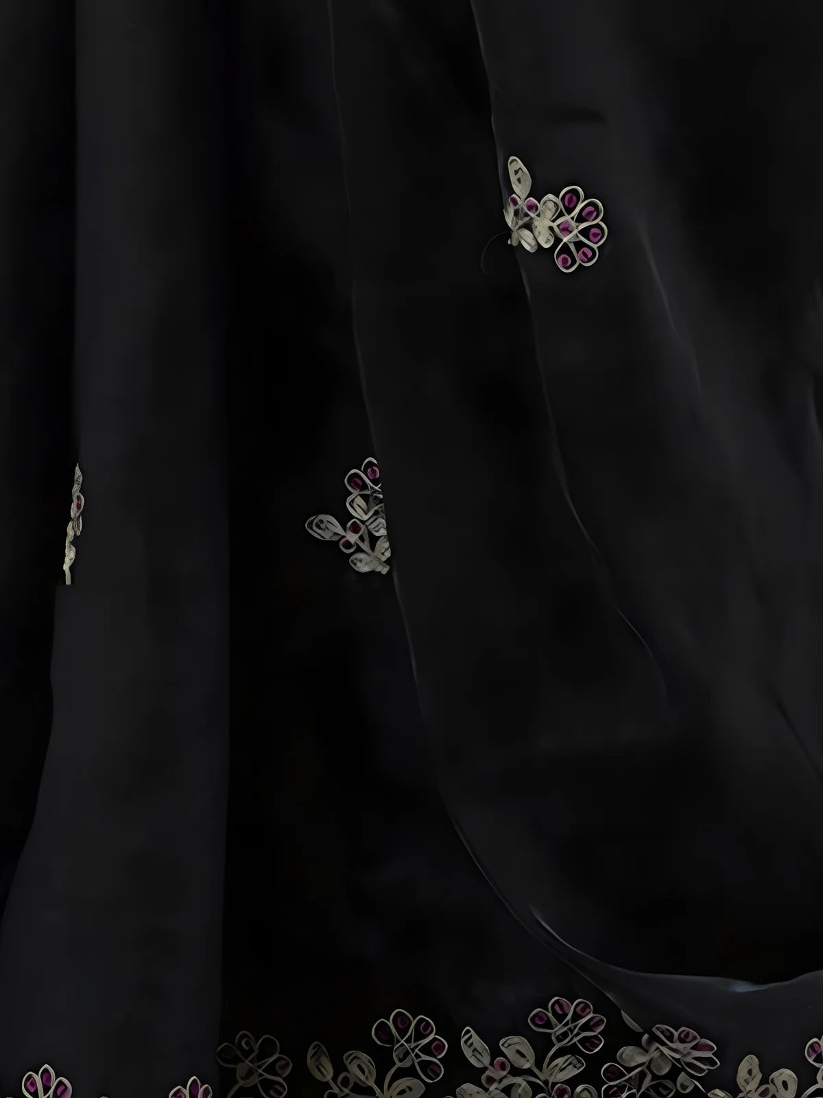 Tarani black saree closeup showing sequin thread embroidery and floral cutwork border details