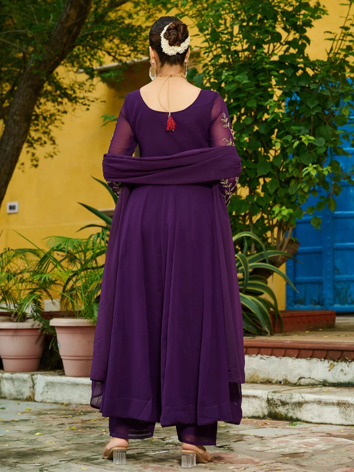 Tarani purple festive dress back side view with gajra hairstyle and flared kurti design