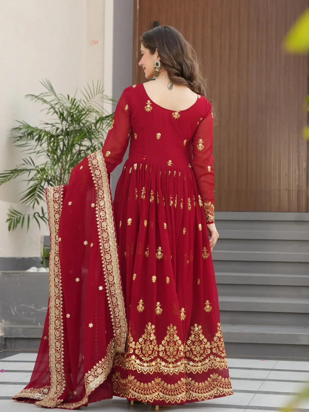 Tarani faux blooming embroidered gown in maroon color showing back design and detailed border work