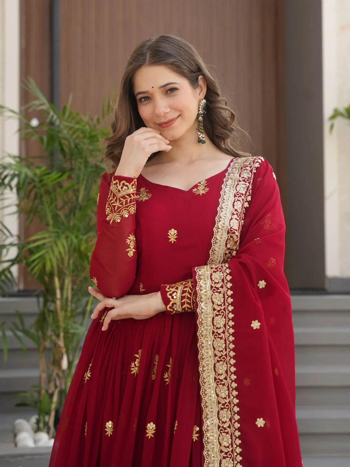 Tarani premium maroon embroidered gown with V-neckline and detailed sleeves in faux blooming fabric