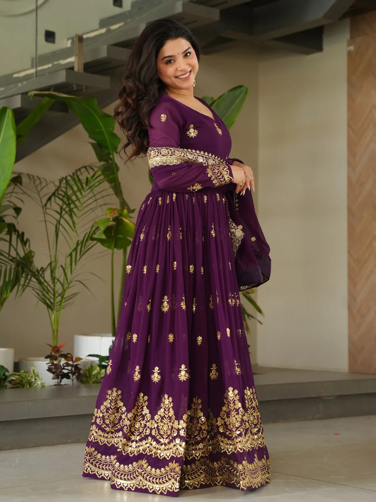 Tarani ethnic faux blooming purple gown side pose showing elegant flare and work