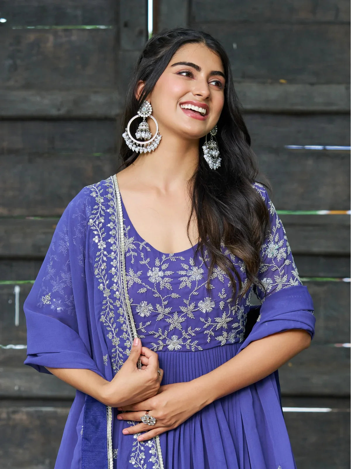Tarani purple faux blooming gown close upper body view showing embroidered blouse and designer earrings