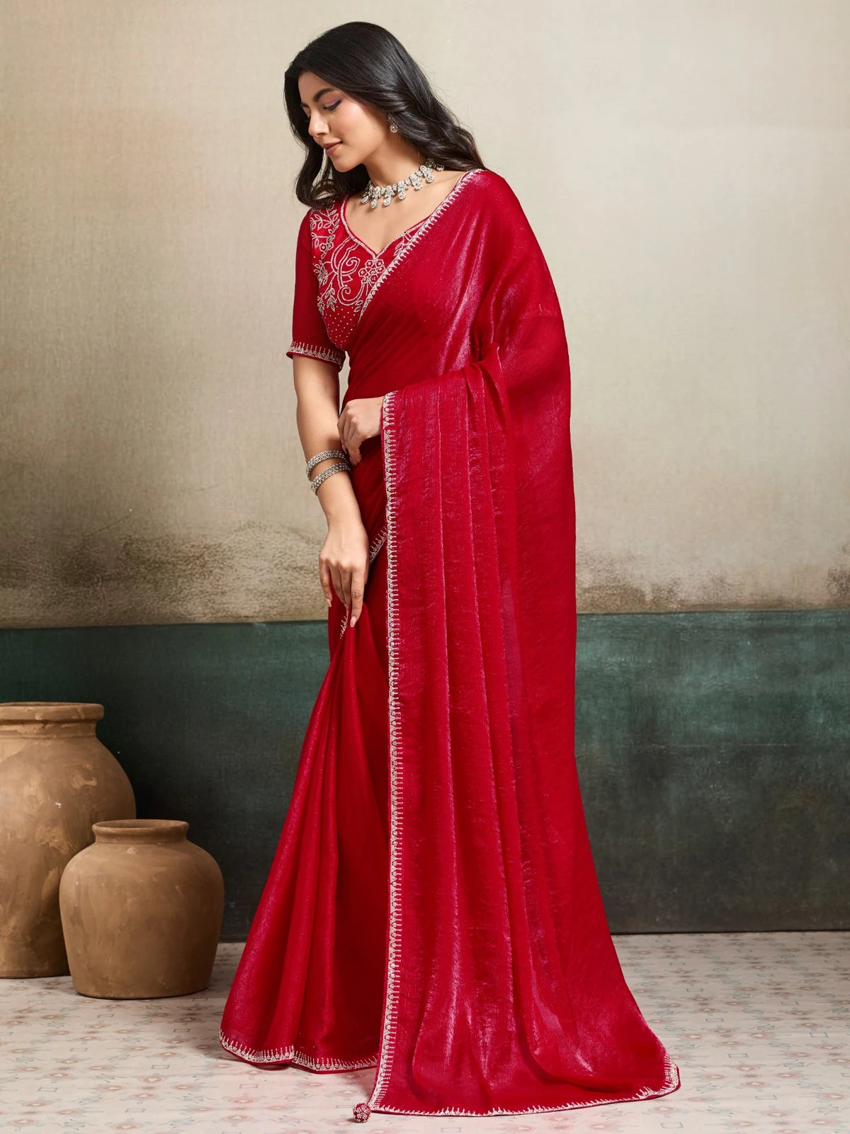 Tarani red party wear saree side view with elegant drape and border