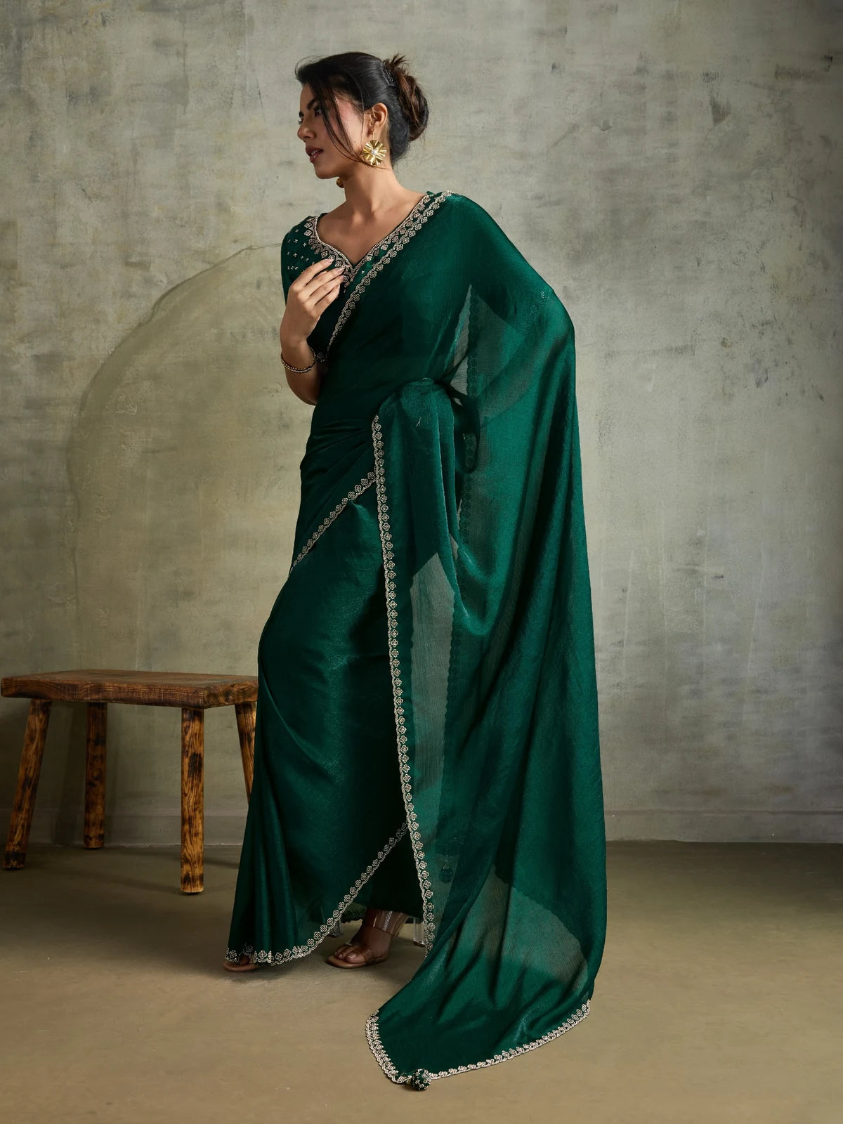 Tarani green chiffon blooming saree side pose with elegant border and party wear styling