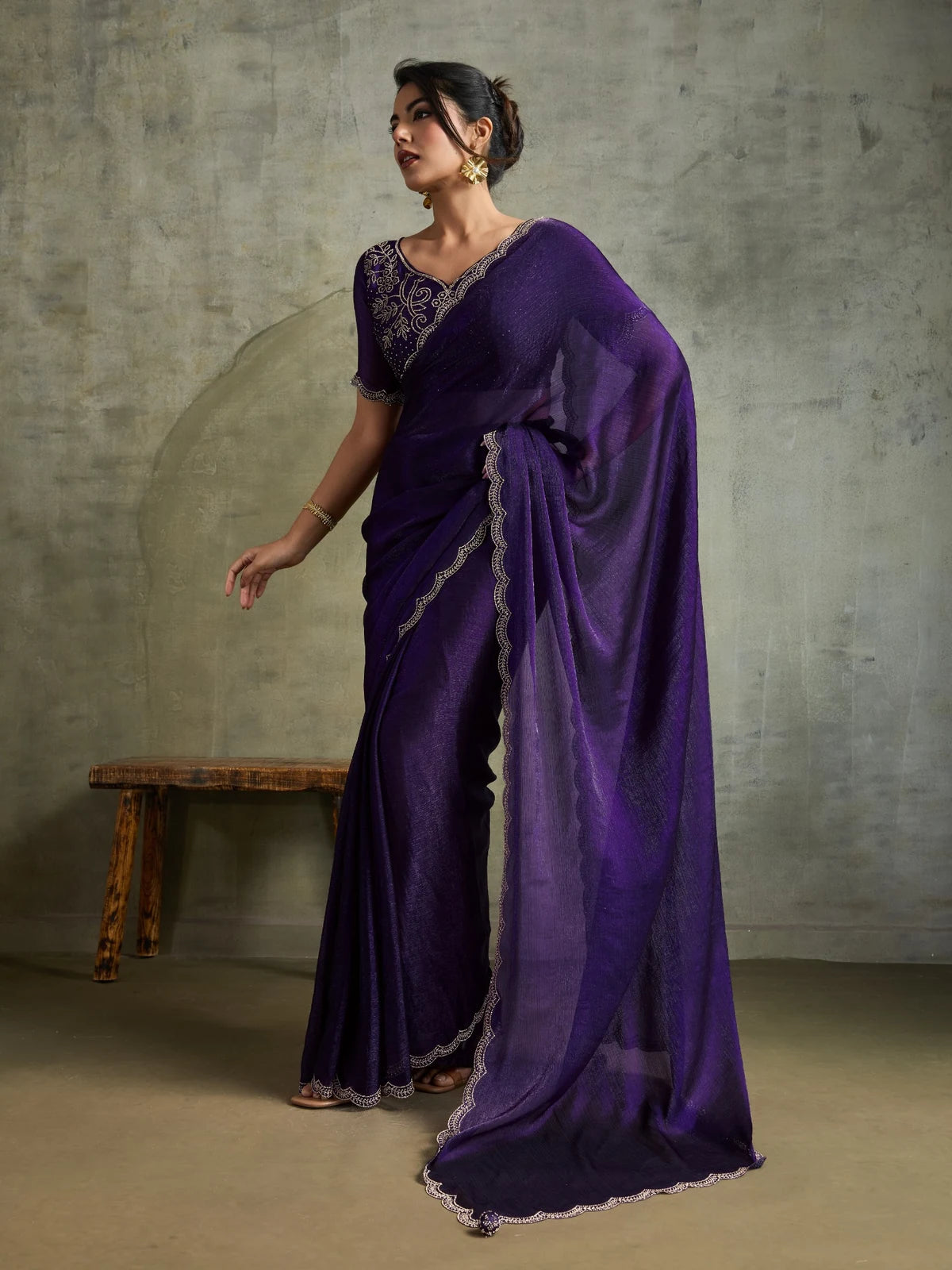 Tarani purple party wear saree side pose with flowing pallu and elegant Zarkan border