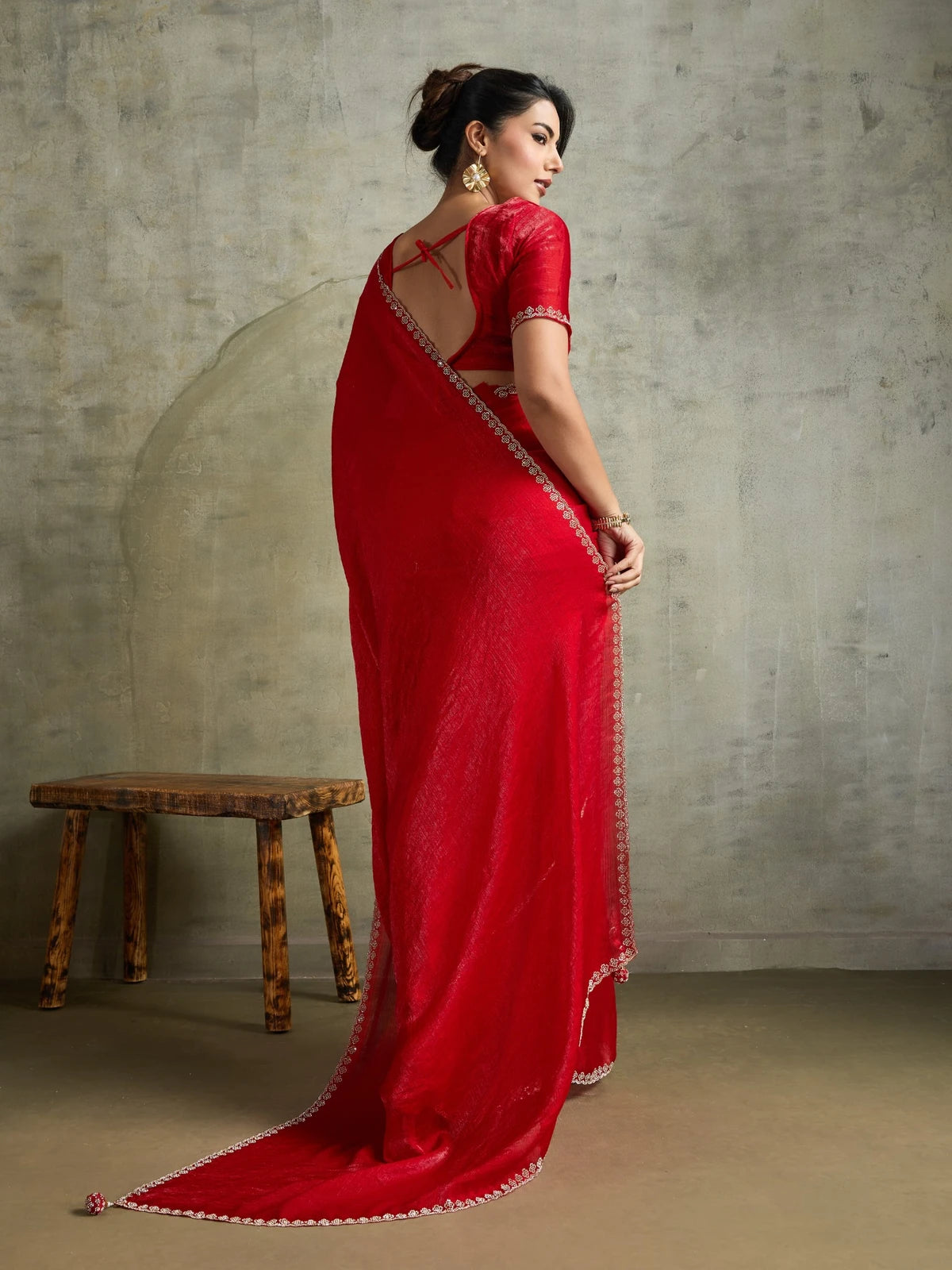 Tarani red chiffon saree back view featuring stylish blouse pattern and border detailing