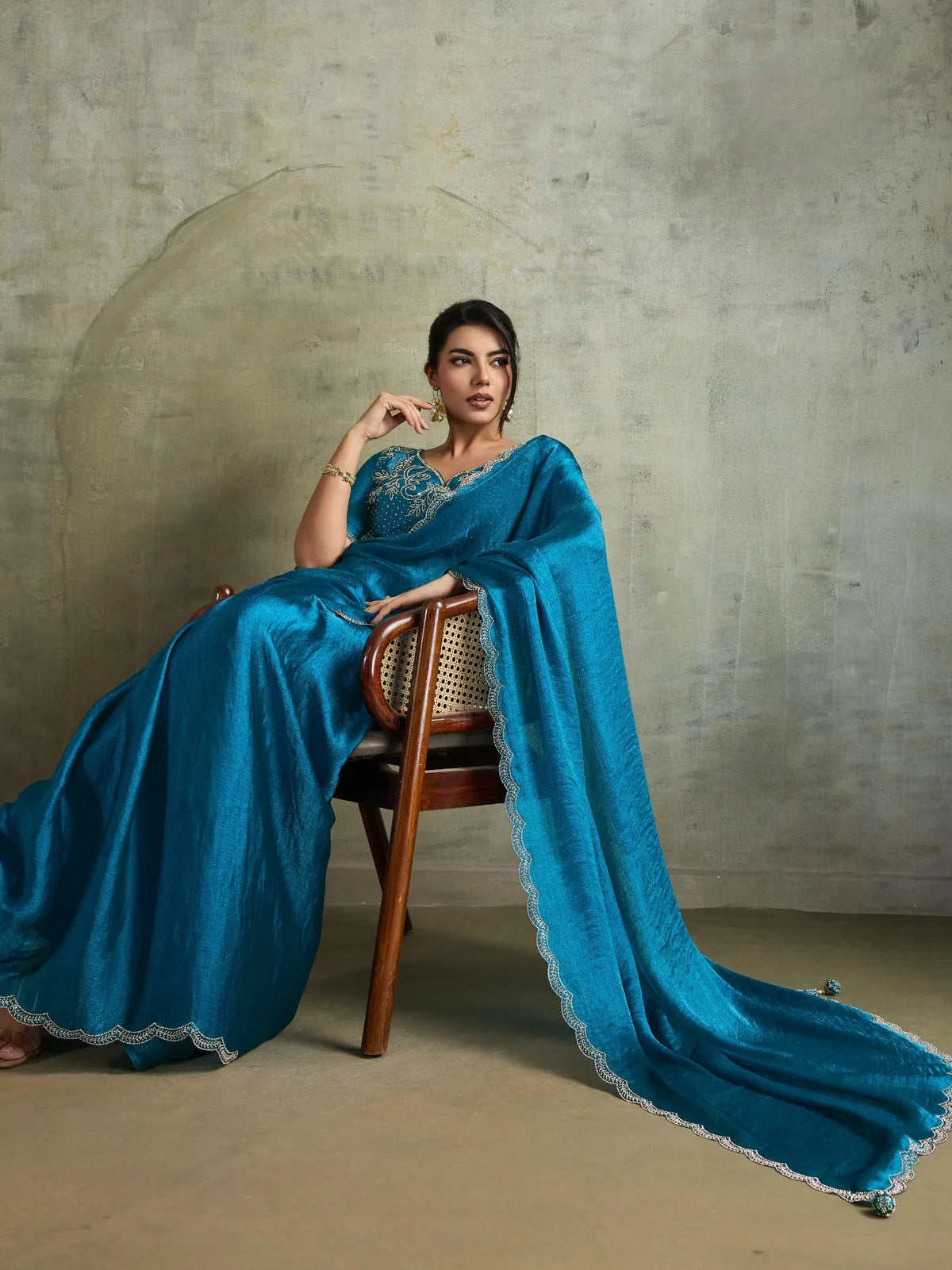 Tarani teal party wear saree with flowing pallu and scallop border detailing by Tarani
