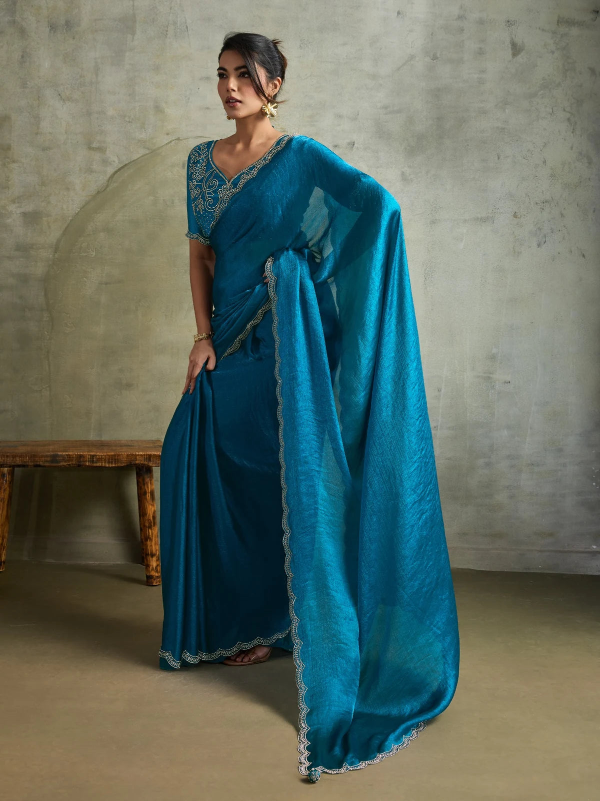 Tarani teal chiffon saree side pose showcasing elegant drape and embroidered blouse styling