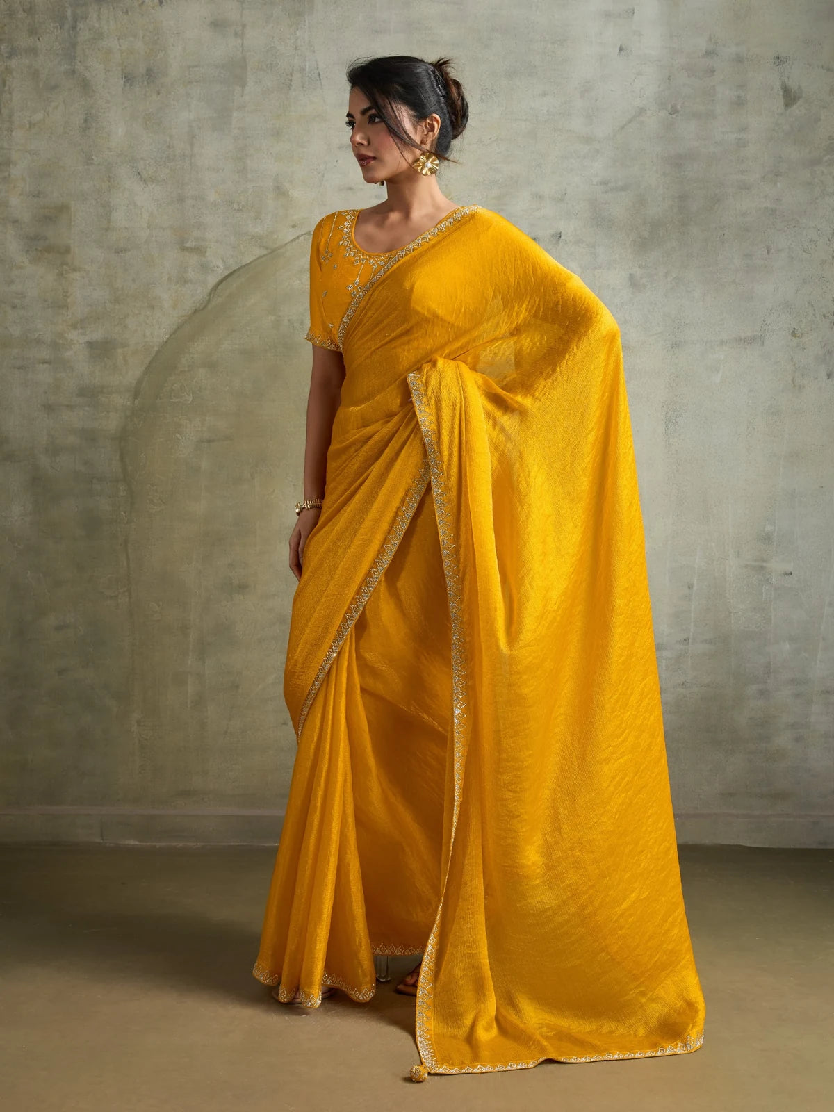Tarani yellow designer saree side view with elegant drape and Zarkan border work