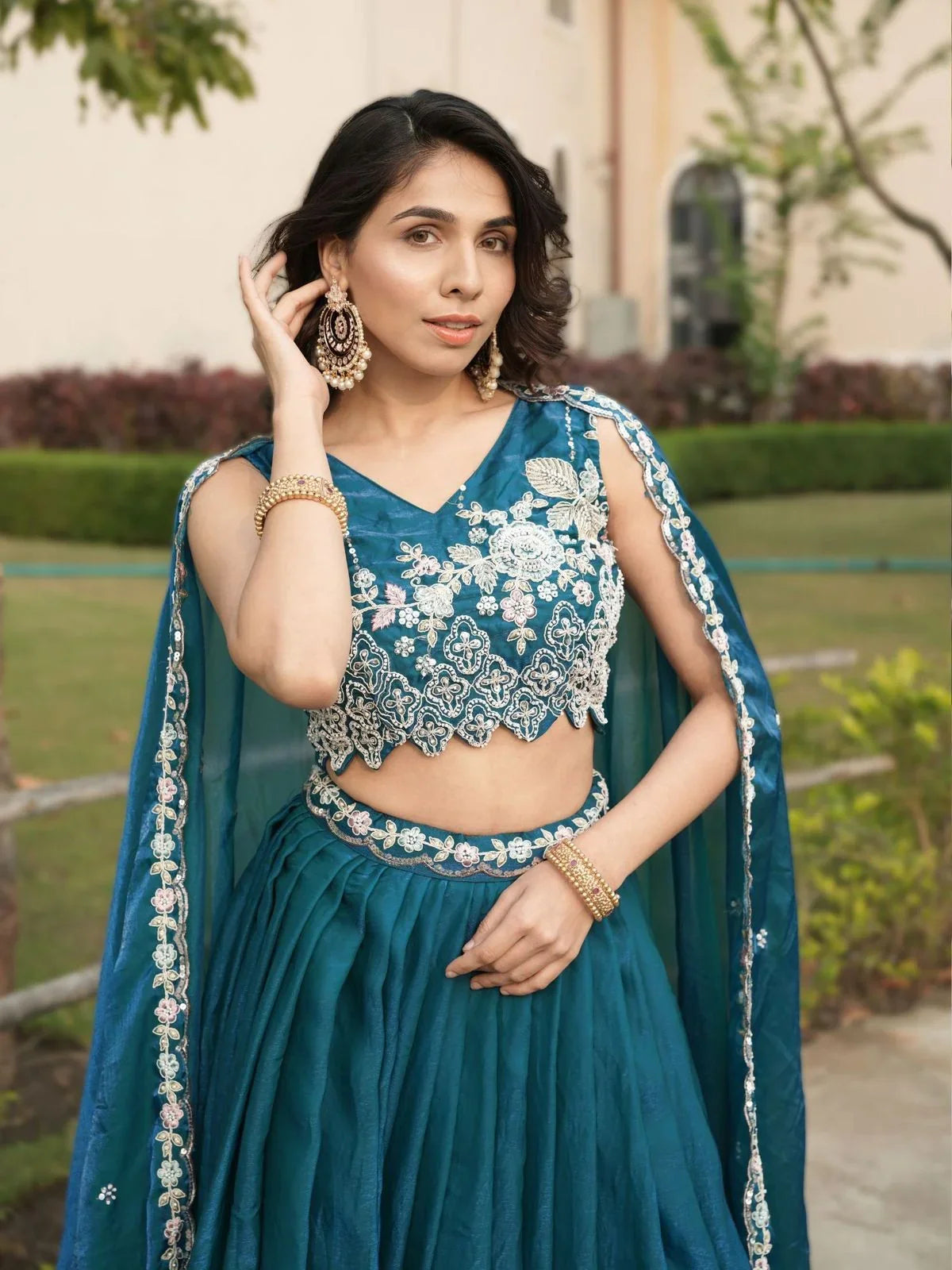 Tarani upper-body view of teal lehenga with intricate blouse embroidery and festive accessories
