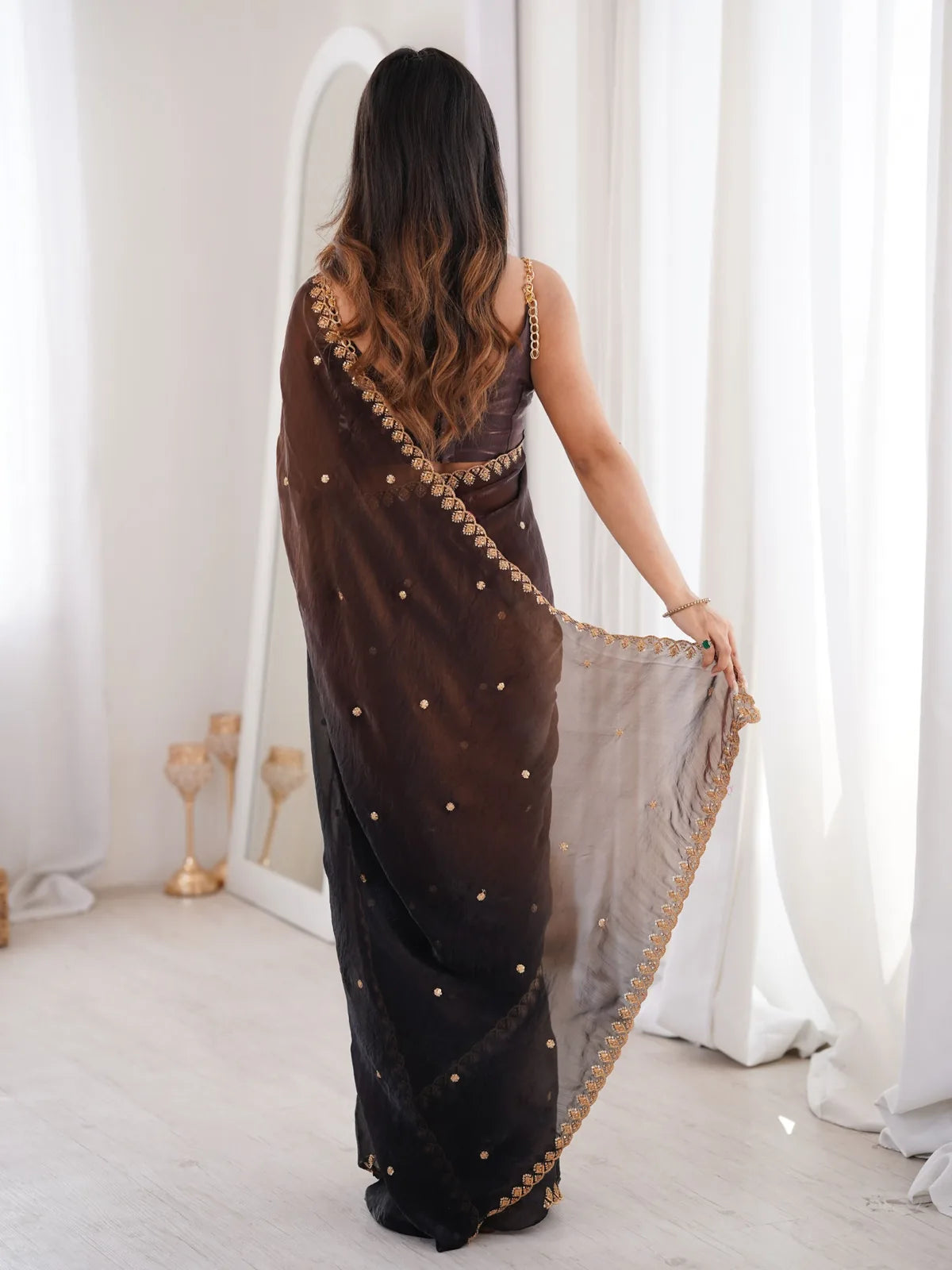 Tarani black Fendy Satin saree back view with embroidered border and flowing pallu