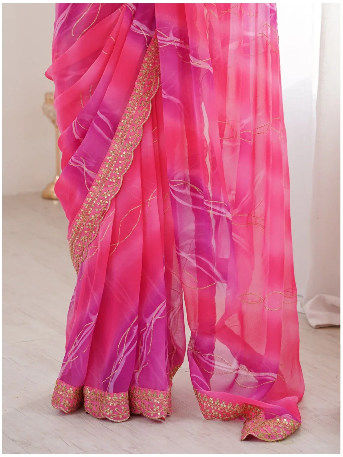 Tarani closeup of pink saree with laheriya gold foil work and embroidered blouse details