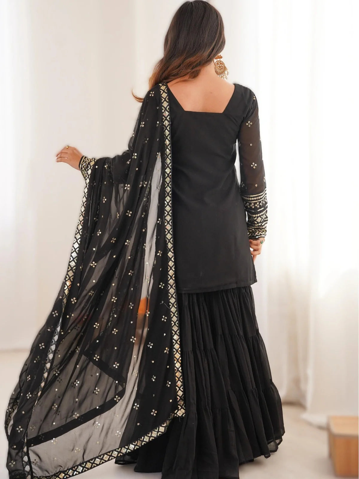 Tarani black georgette dress back view highlighting elegant fall and dupatta border work