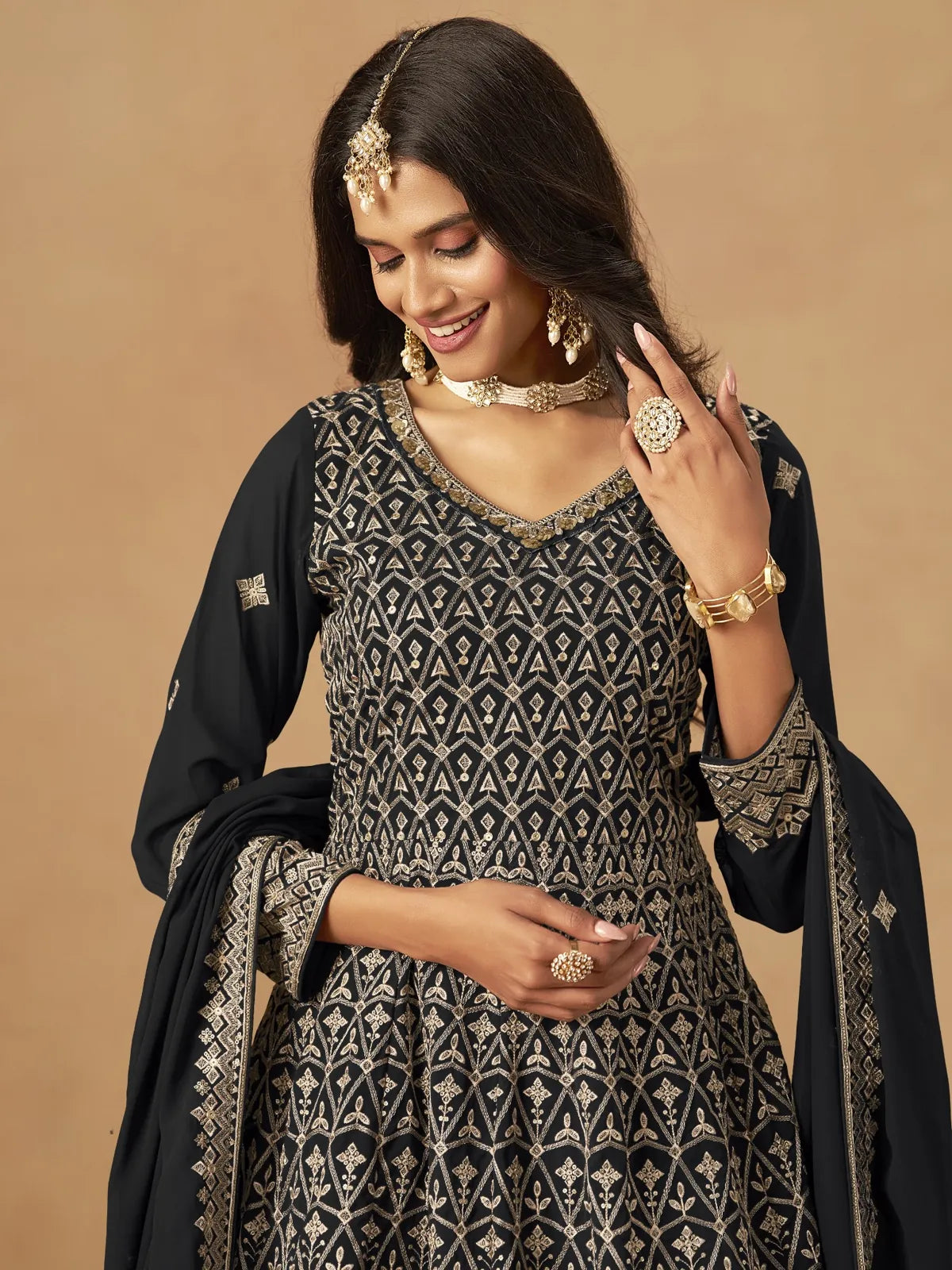 Tarani black georgette dress upper body view with intricate golden motifs